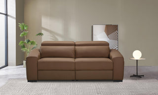 Brown sofa in a modern living room with a plant and side table.