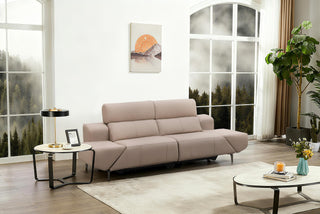 Modern living room with a beige recliner sofa, coffee table, and decorative elements.
