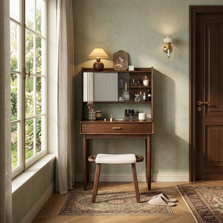 dark wood dressing table with shelves and a stool in a room with a large window and door.