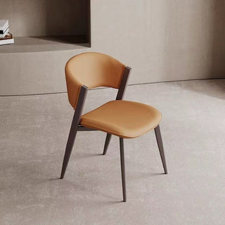 dining chair with orange seat and backrest on a neutral floor