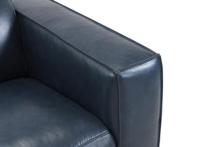 Close-up of a black leather armchair corner on a white background