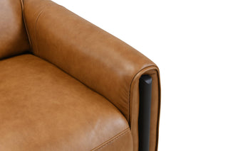 Close-up of a brown leather sofa armrest on a white background