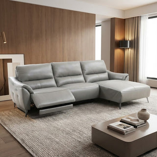 grey sectional sofa in a modern living room with wooden walls and a coffee table.
