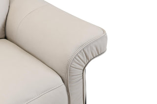 Close-up of a beige sofa corner on a white background