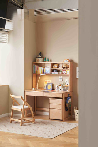 kids desk with chair in a room with shelves and decor