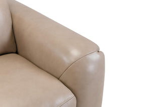 Close-up of a beige leather sofa armrest on a white background