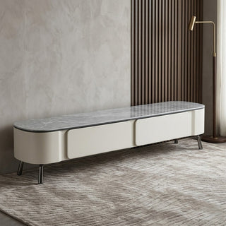 minimalist tv console with sintered stone top in a room with a textured wall and floor.