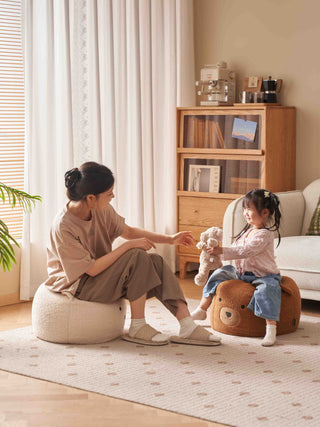 mother and child sitting on kids bean bag chairs in a cozy living room