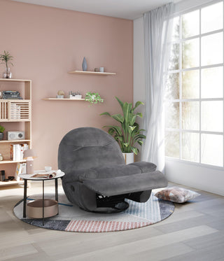 Gray manual recliner armchair in a modern living room with pink walls and large windows.