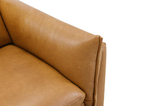 Close-up of a brown leather sofa corner on a white background