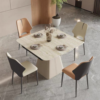 small extendable Dining table set with four chairs on a gray tiled floor.