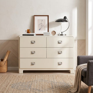white gloss chest of drawers with decorative items in a room setting